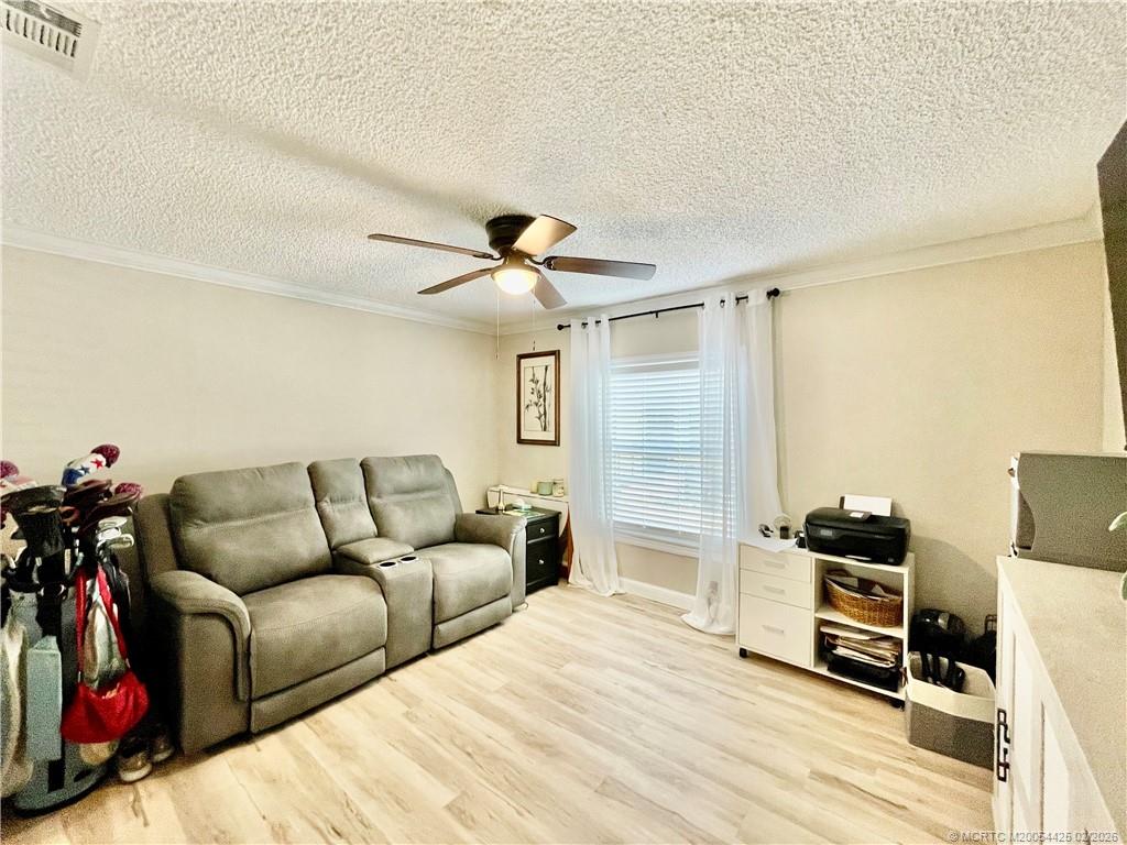 14513 Southwest Rake Drive Indiantown, FL 34956 - Photo 23 of 32 Guest bedroom used as a den. new flooring & fan