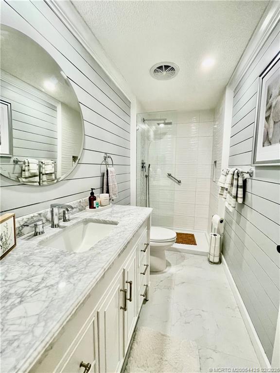 14513 Southwest Rake Drive Indiantown, FL 34956 - Photo 25 of 32 Guest bathroom. Shiplap walls, new vanity, shower tile w/rain shower, vinyl floors, pot ceiling lights, new toilet & plumbing.