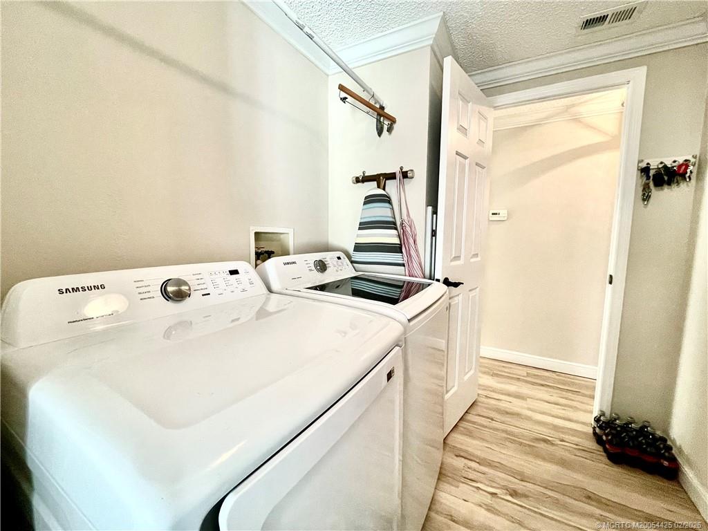 14513 Southwest Rake Drive Indiantown, FL 34956 - Photo 28 of 32 new washer & dryer, new storage cabinet & new hot water tank