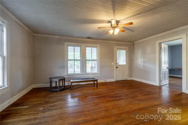 wooden floor in an empty room with a window