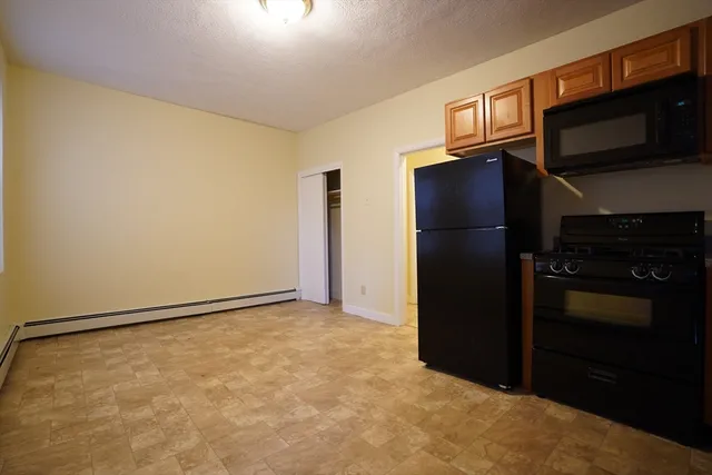 a kitchen with a refrigerator cabinet and microwave