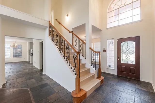 a view of entryway and hall with a front door