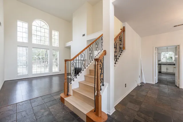 a view of entryway and hall with wooden floor