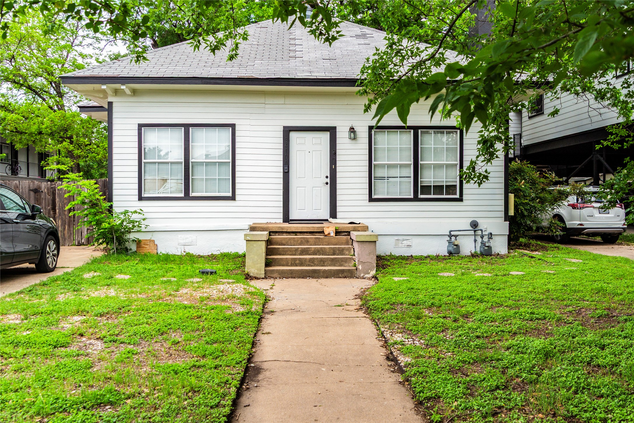 3410 Speedway, Unit A Austin, TX 78705 - Photo 1 of 9 a front view of a house with a garden and trees
