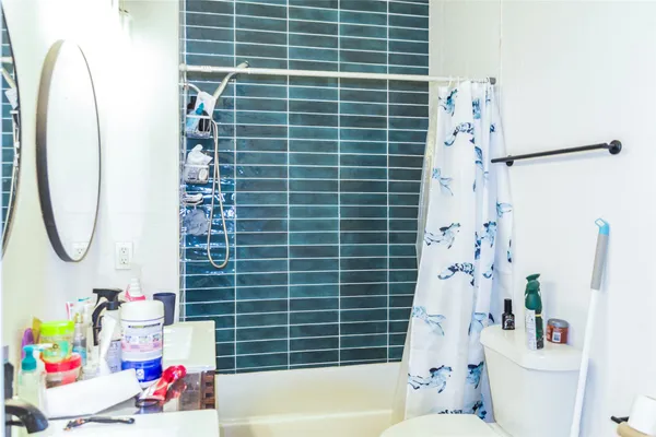 a bathroom with a bath tub a sink and a shower curtain