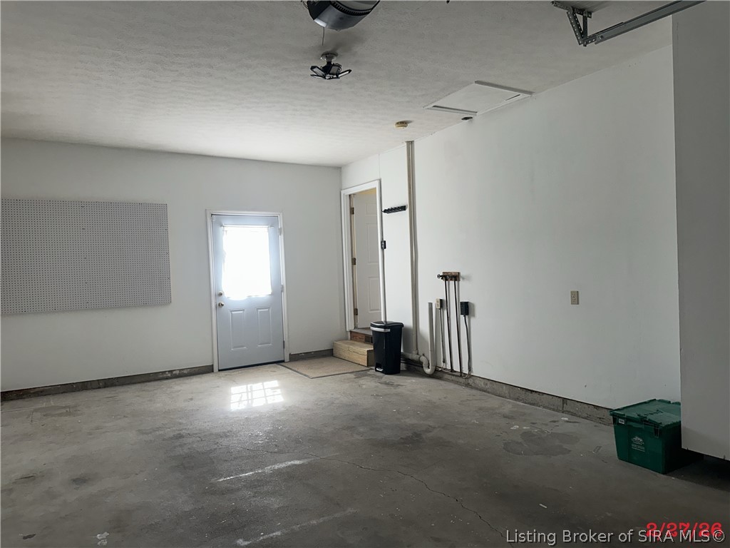 1801 Rita Drive New Albany, IN 47150 - Photo 22 of 37 Besides opener this garage has additional washer and dryer hook ups and peg board. To the right at the garage entrace are shelves that have been built to help hold all those garage items.