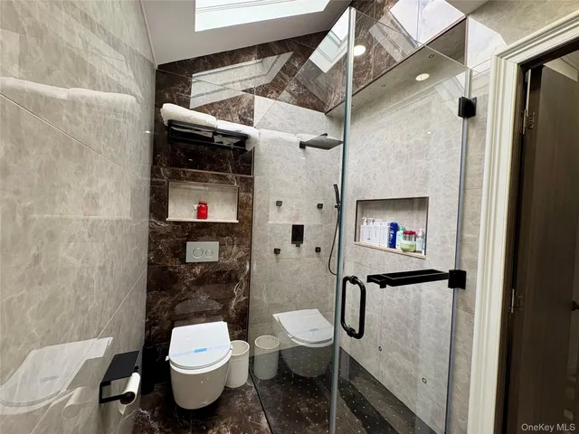 a bathroom with a toilet sink and shower