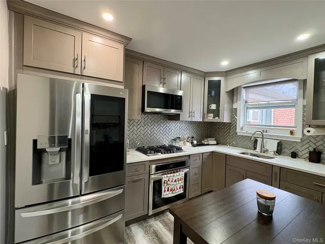 a kitchen with a refrigerator a sink and cabinets