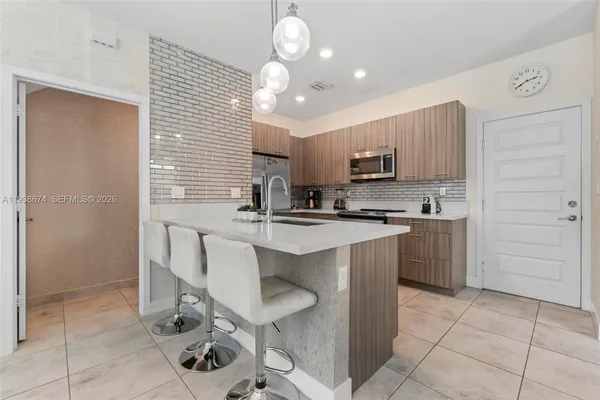 a kitchen with a sink cabinets and window