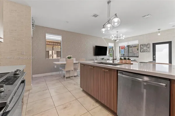 a kitchen with a sink stainless steel appliances and cabinets