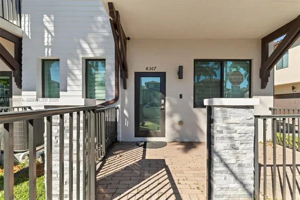 a view of a balcony with wooden floor and fence