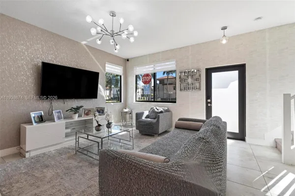 a living room with furniture and a flat screen tv
