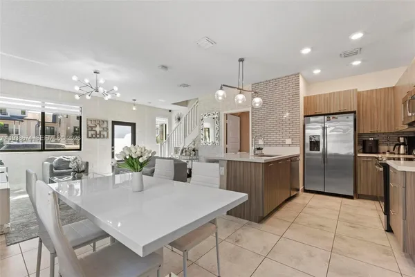 a large kitchen with a table and chairs
