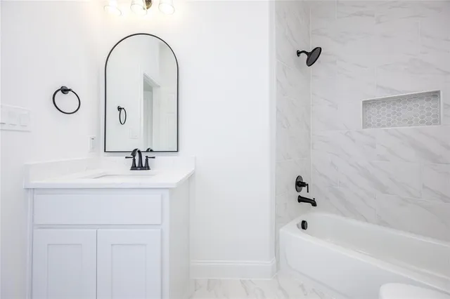 a bathroom with a sink a mirror and a bathtub