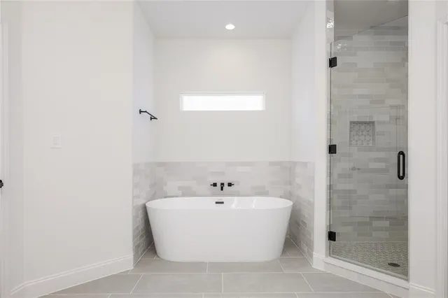 a white bath tub sitting next to a white sink