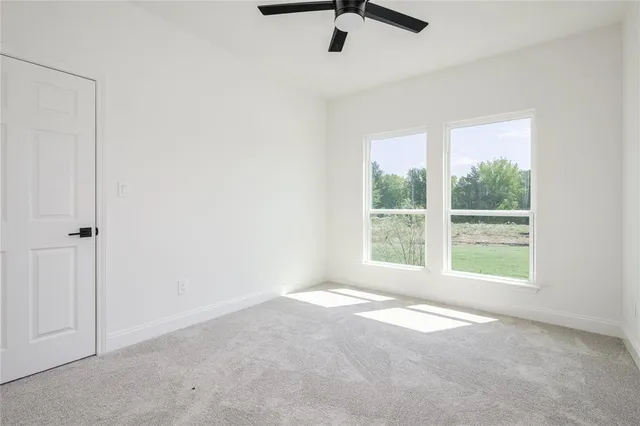 an empty room with windows and closet