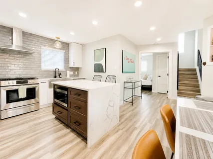 a kitchen that has a table and chairs in it