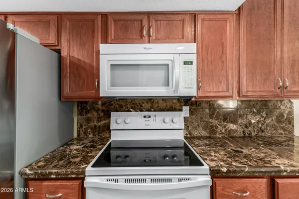 a stove top oven sitting inside of a kitchen
