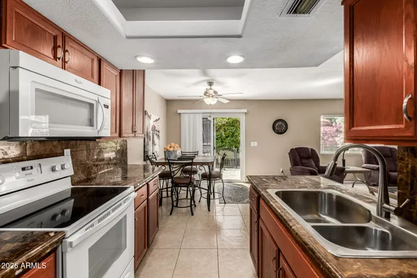 a kitchen that has a sink a stove and oven