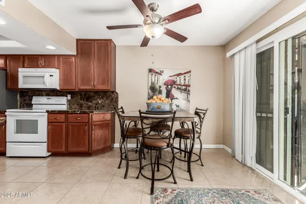 a kitchen with a table chairs and a refrigerator