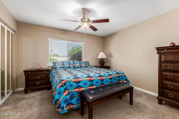 a bedroom with a bed and a dresser