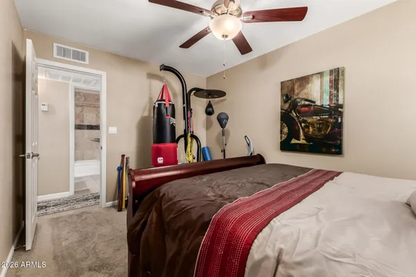 a bedroom with a bed and a large mirror