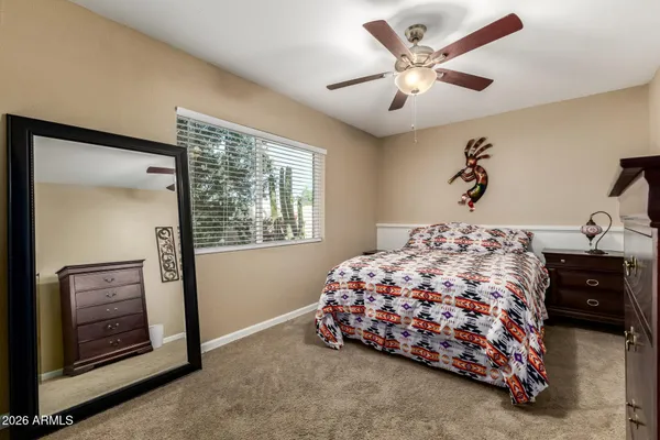 a bedroom with a bed and a painting on the wall