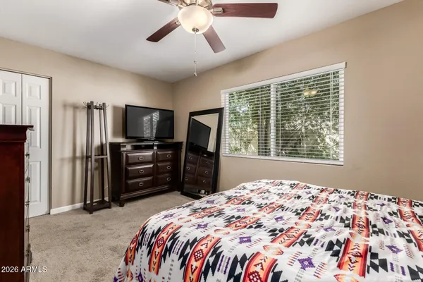 a bedroom with a bed closet and a window