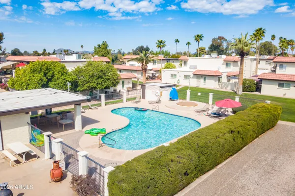 an aerial view of a swimming pool and outdoor seating