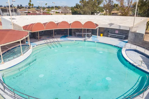 a view of a swimming pool with lounge chairs