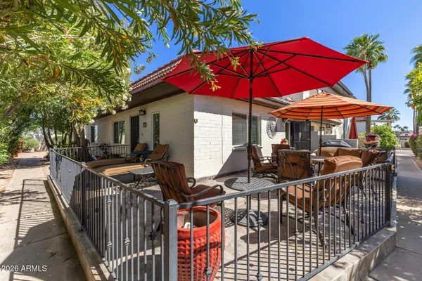 a view of a patio with a table and chairs under an umbrella