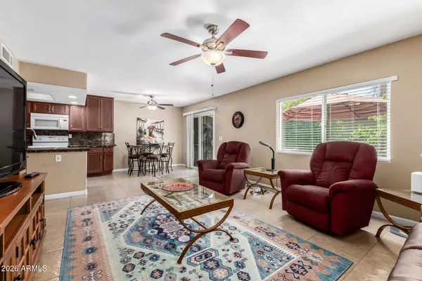 a living room with furniture a table and a large window