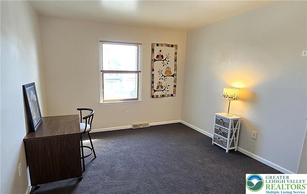 194 Springhouse Road Allentown, PA 18104 - Photo 25 of 34 This cozy bedroom features a bright window and soft carpeting, creating a comfortable living space.