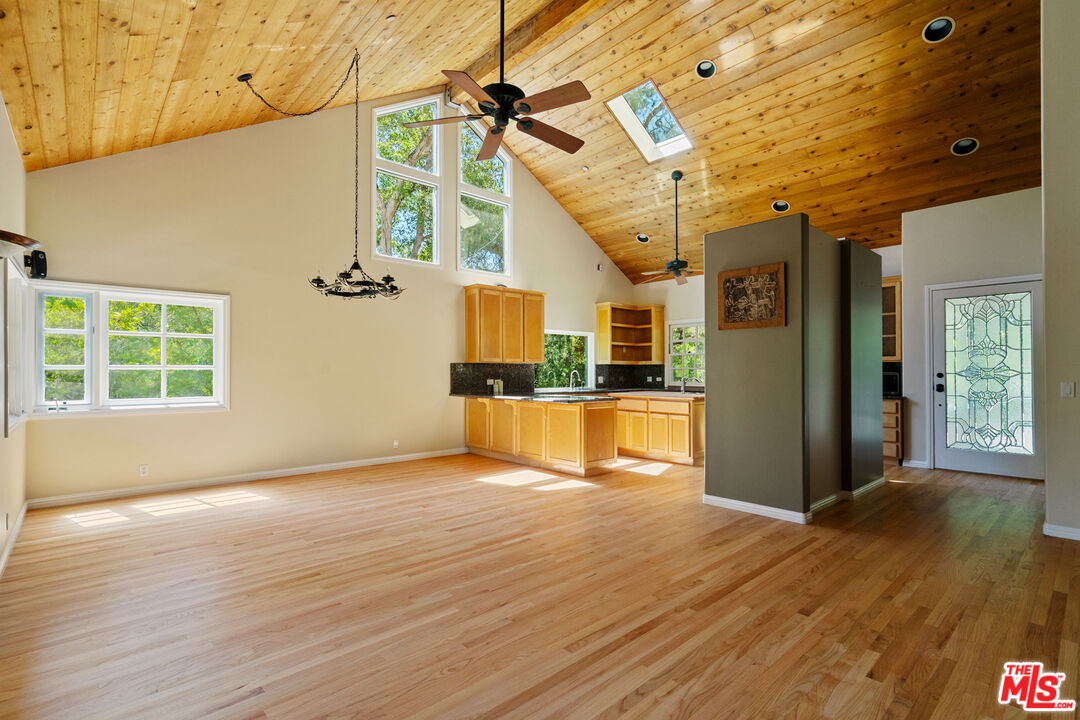 20912 Fontaine Road Topanga, CA 90290 - Photo 5 of 52 a view of empty room with wooden floor and windows