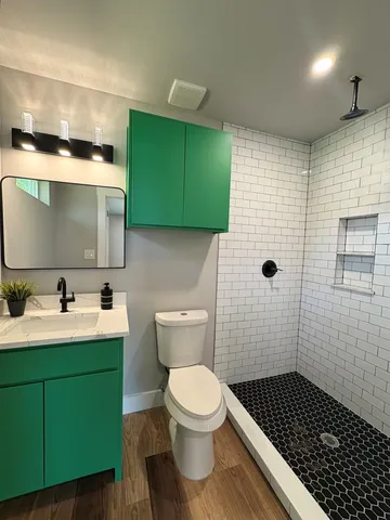 a bathroom with a sink toilet and shower