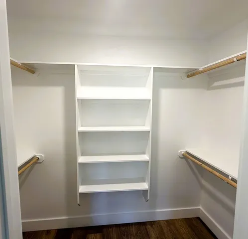 a view of walk in closet with empty racks