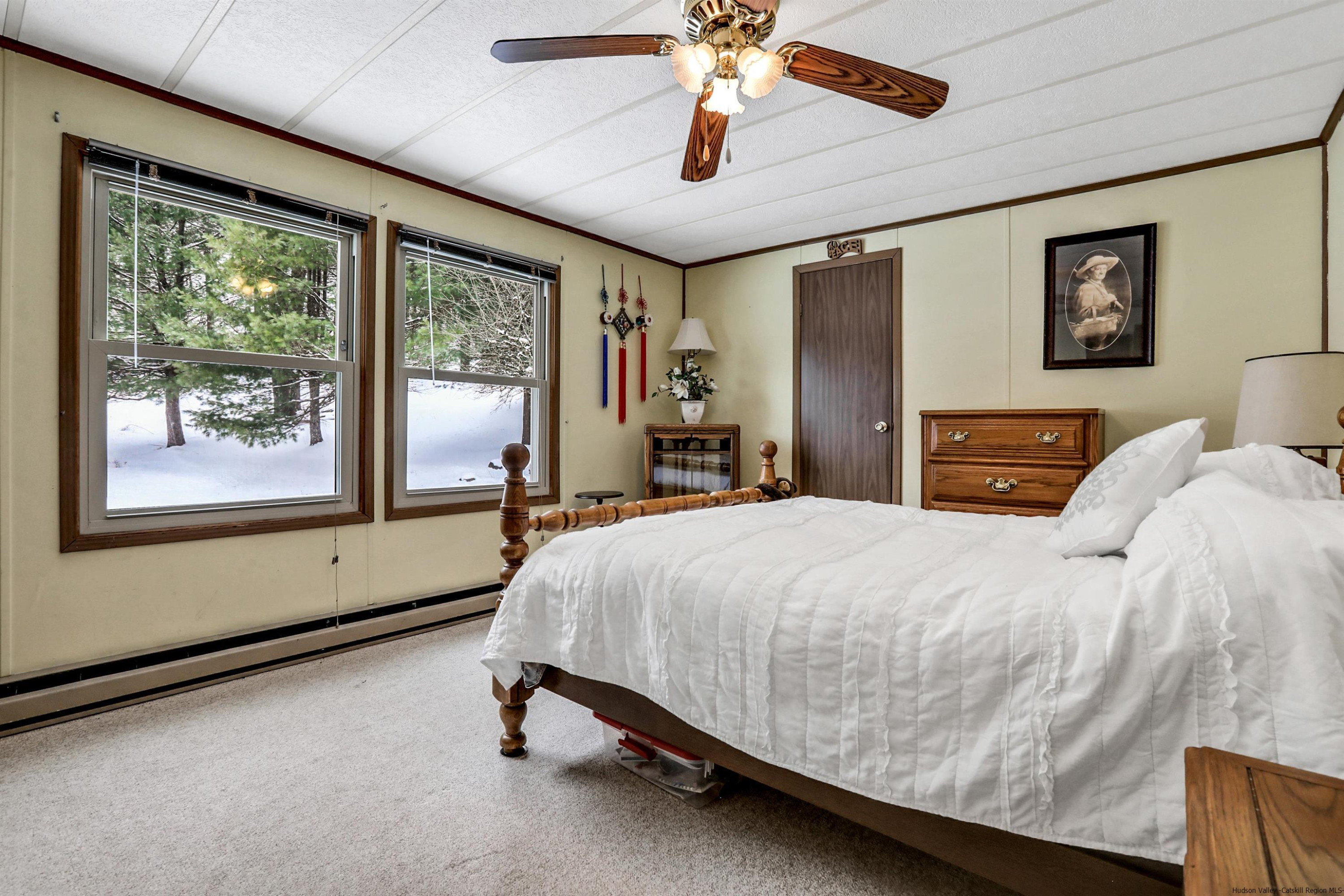 60 Grandview Acres Road Phoenicia, NY 12464 - Photo 15 of 21 a bedroom with a large bed and a chandelier