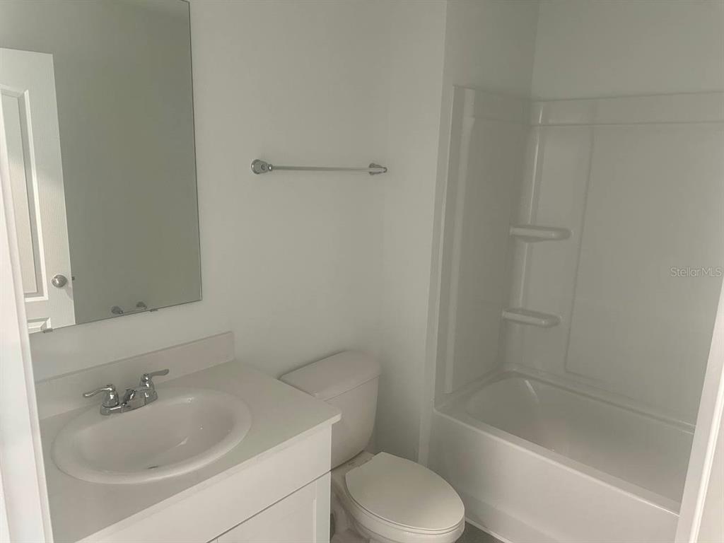 455 Redbud Road Palm Coast, FL 32137 - Photo 5 of 12 a bathroom with a sink toilet and bathtub