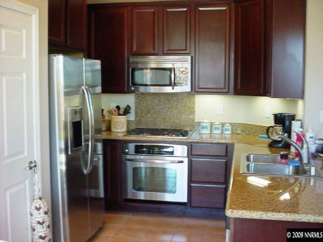 1791 A Wind Ranch Road Reno, NV 89521 - Photo 3 of 9 a kitchen with a stove and a microwave