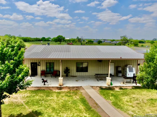 a view of a house with swimming pool and furniture