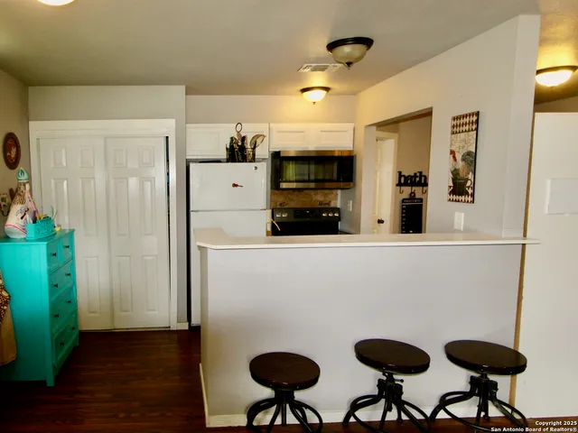 a kitchen with stainless steel appliances a refrigerator and a stove top oven