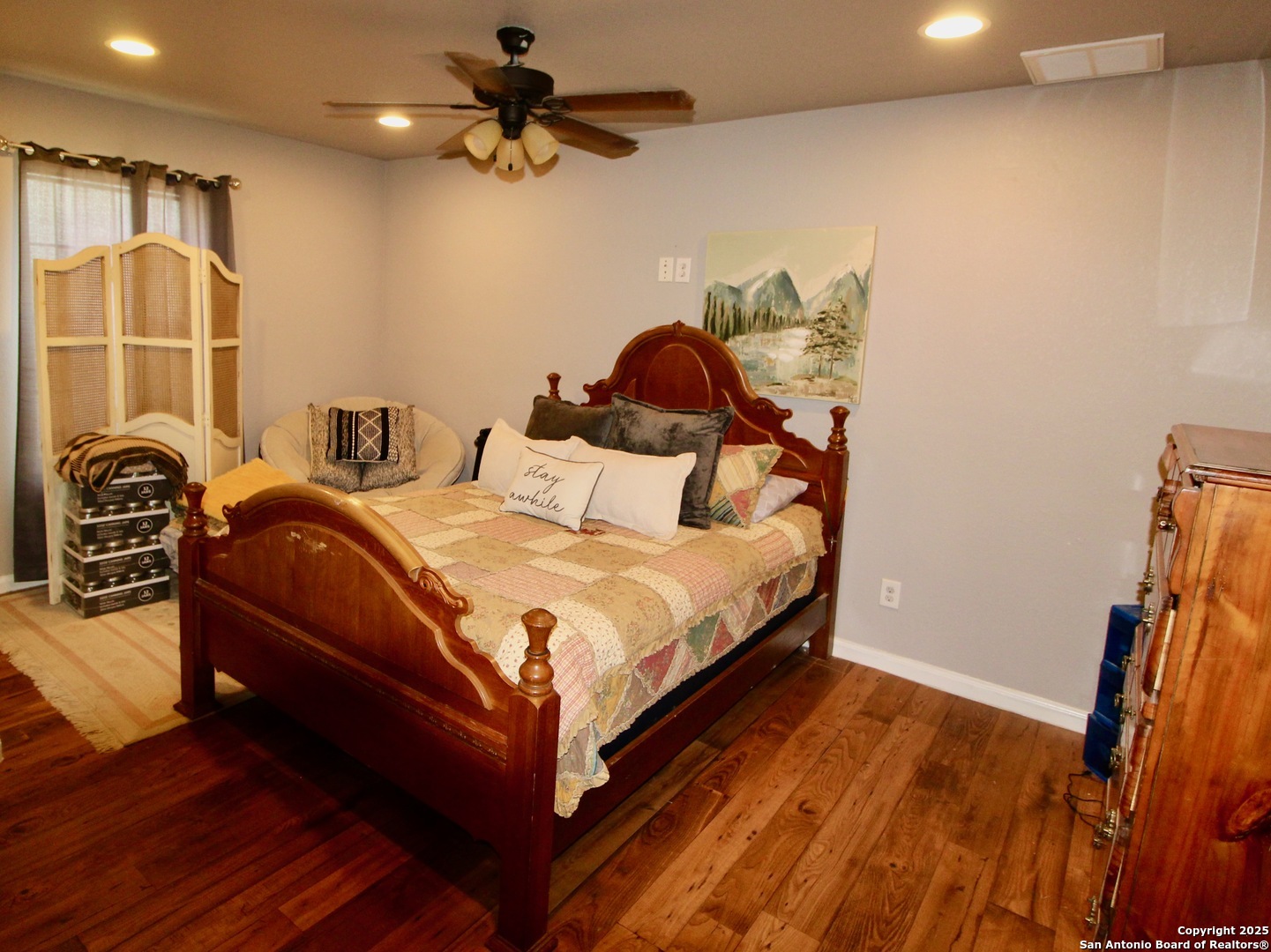 12365 Rudolph Road, Unit 3 Atascosa, TX 78002 - Photo 24 of 42 a bedroom with a bed and a chandelier