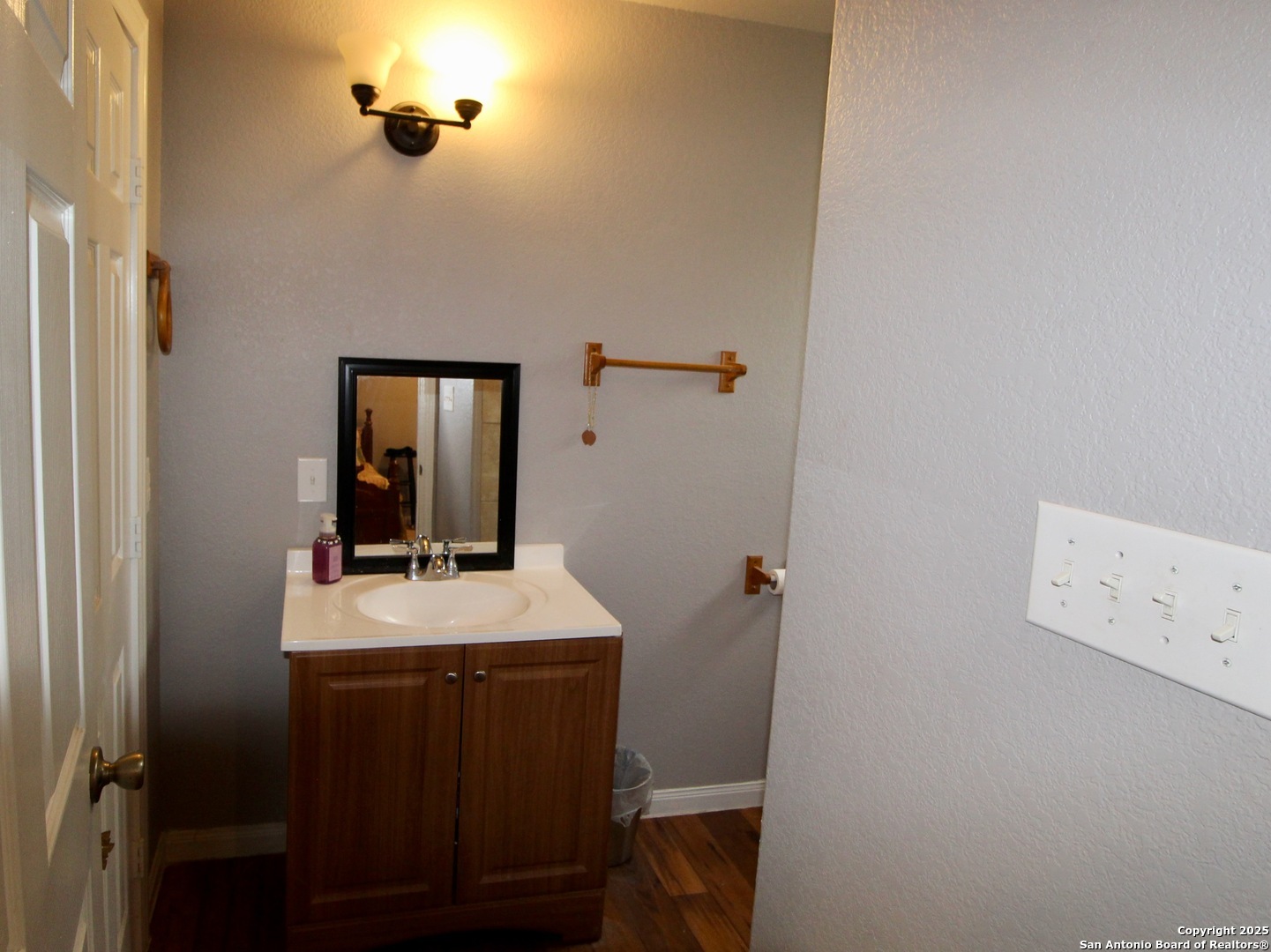 12365 Rudolph Road, Unit 3 Atascosa, TX 78002 - Photo 26 of 42 a bathroom with a sink a mirror and vanity