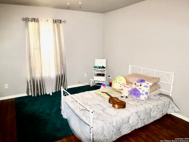 a bed sitting in a bedroom next to a window with yard