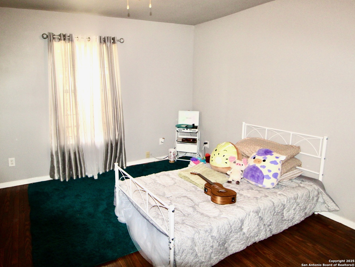 12365 Rudolph Road, Unit 3 Atascosa, TX 78002 - Photo 28 of 42 a bed sitting in a bedroom next to a window with yard