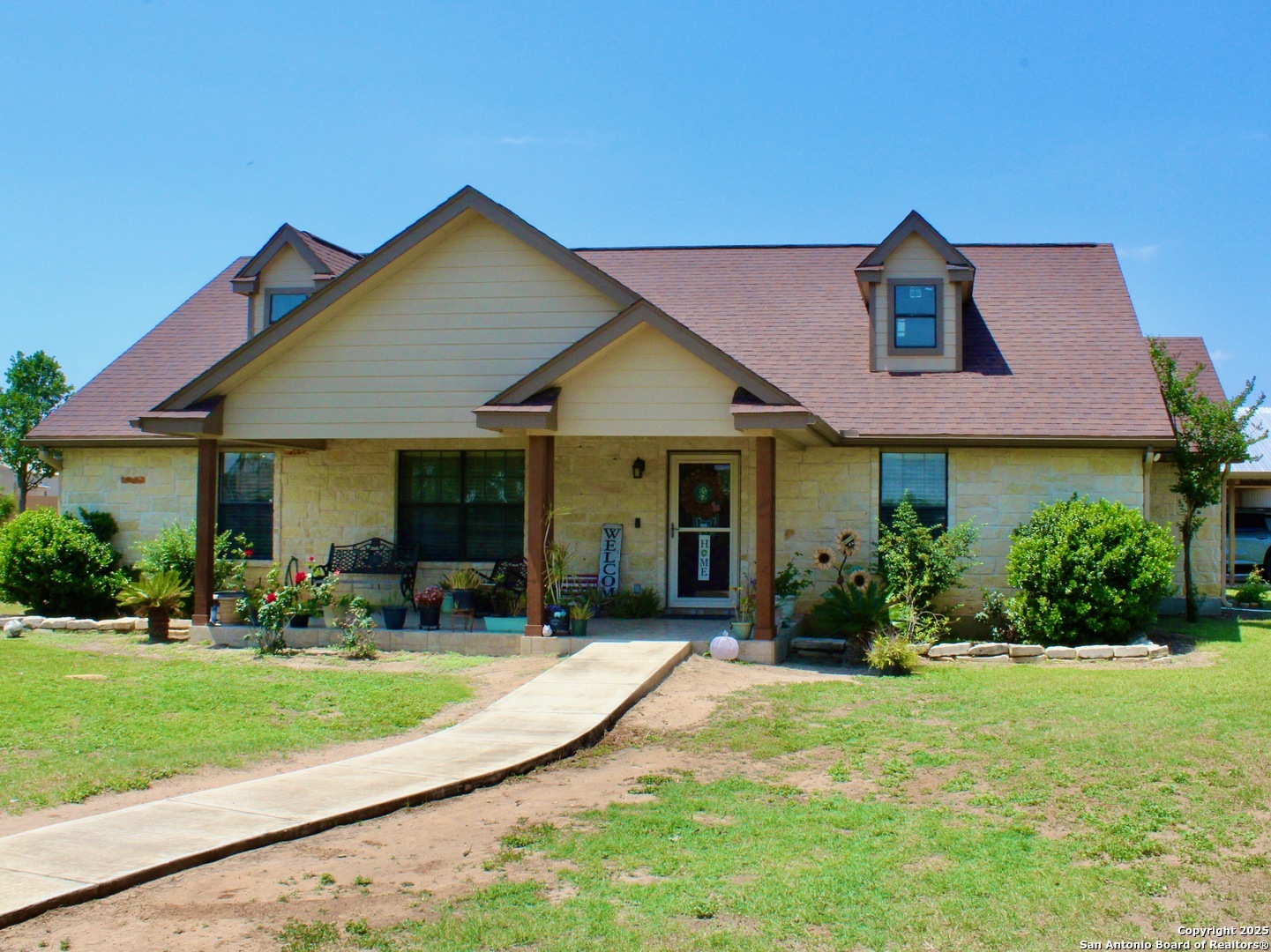 12365 Rudolph Road, Unit 3 Atascosa, TX 78002 - Photo 3 of 42 a front view of a house with garden