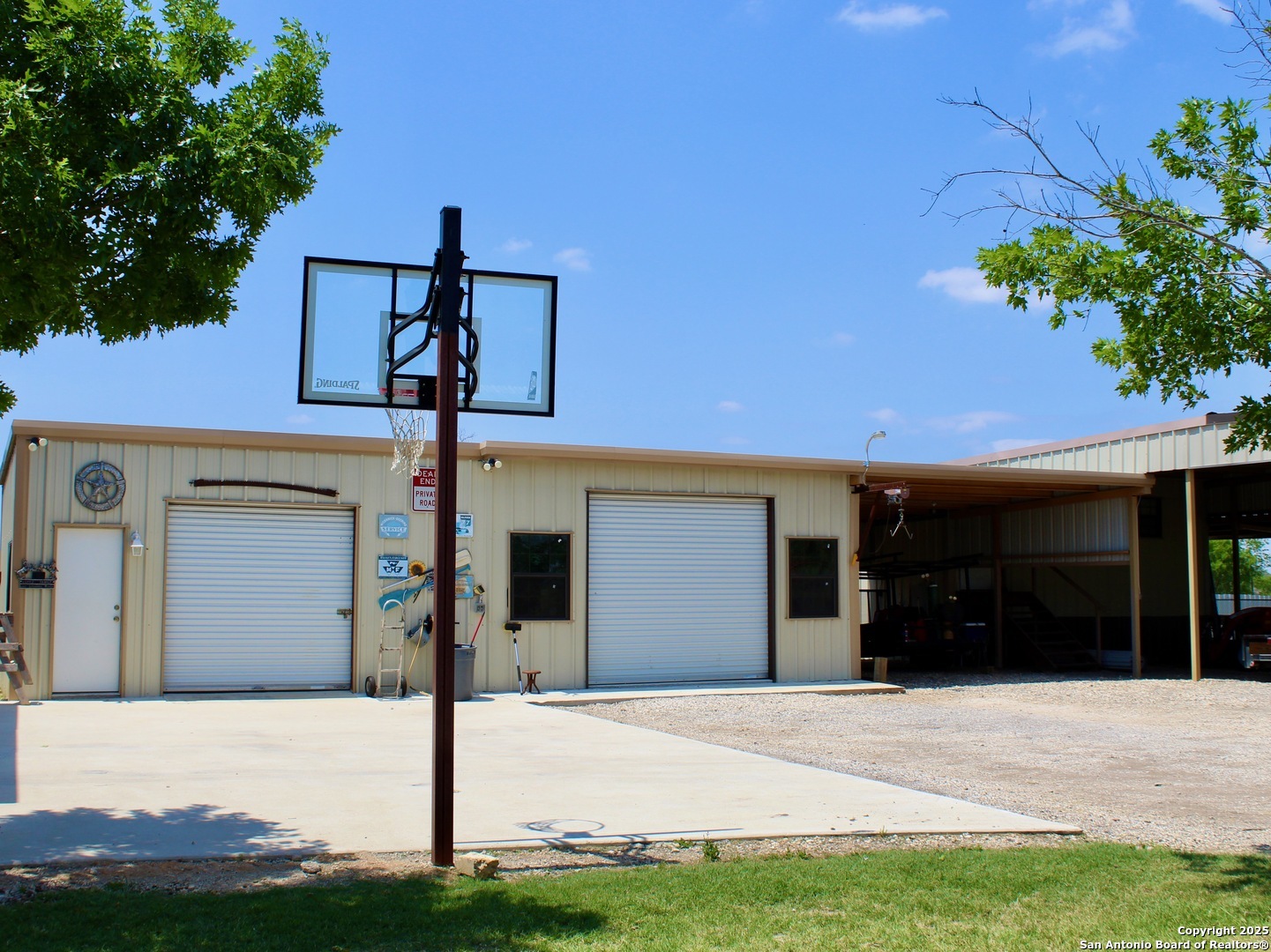12365 Rudolph Road, Unit 3 Atascosa, TX 78002 - Photo 34 of 42 a front view of a house with a yard and garage