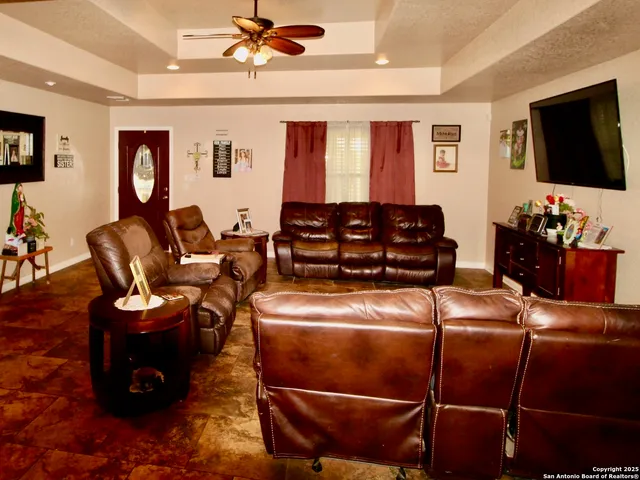 a living room with furniture a flat screen tv and gym equipment