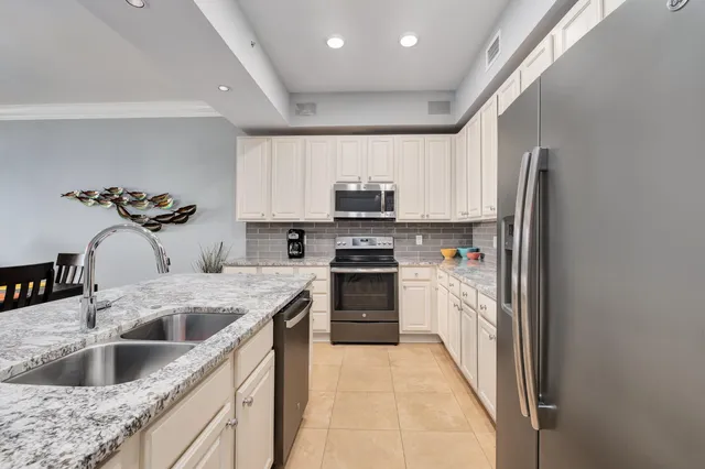 a kitchen with a sink cabinets and stainless steel appliances