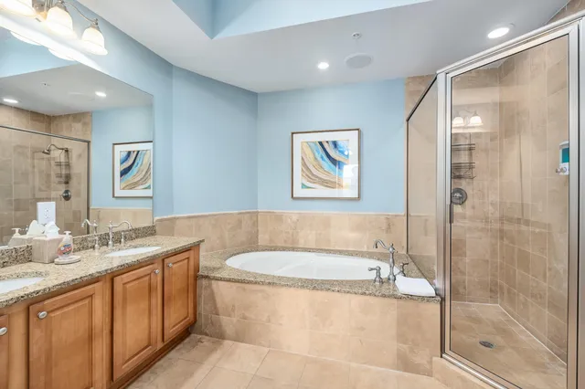 a bathroom with a granite countertop sink mirror toilet and bathtub